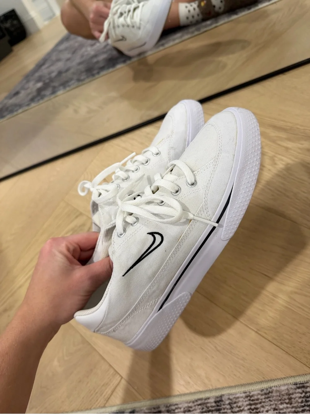 Nike Women’s White Canvas Sneakers with Black Swoosh